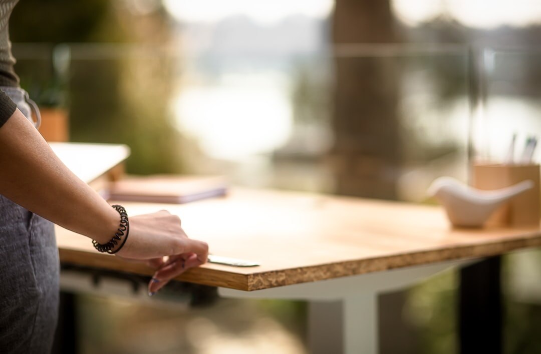 woman writing book at desk